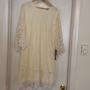Beautiful ivory cream lace sheath dress, knee length with polyester lining.